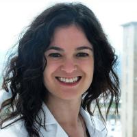 Portrait image of Dr. Hannah Rosenblum in her white lab coat